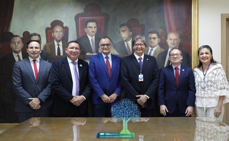 Foto do servidor nomeado. Ele posa ao lado de magistrados e da diretora-geral após cerimonia de posse na antessala da presidênci