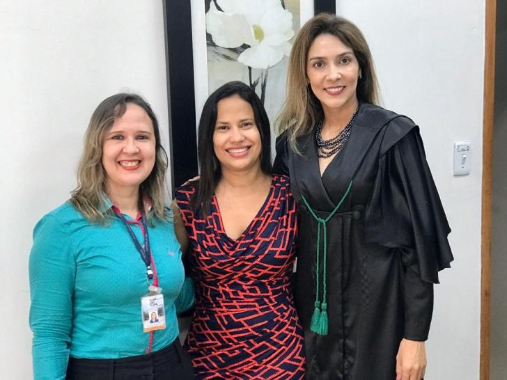 Foto: Servidora que tomou posse ao centro e juíza e servidora da VT nas extremidades.