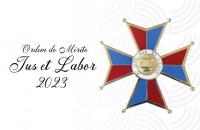 Arte gráfica com o fundo branco. Alinhado à esquerda, o texto "Ordem do Mérito Jus et Labor 2023" em preto.