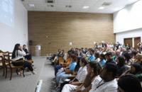 Foto do auditório do TRT-8 em Belém. O local é amplo, claro, e está lotado de servidores e colaboradores. 