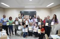 #ParaTodosVerem: Foto colorida de servidoras e servidores em ambiente fechado