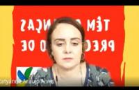 Imagem da juíza Tatyanne Alves  na sessão telepresencial. Ao fundo, painel sobre a campanha de doação e resmas de papel.